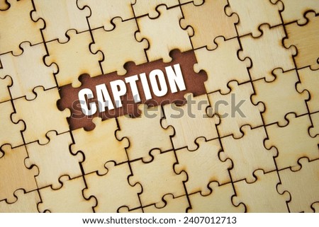 wooden puzzle with caption words. the concept of sentence usage or the structure of something. a title or brief explanation accompanying an illustration, cartoon, or poster.