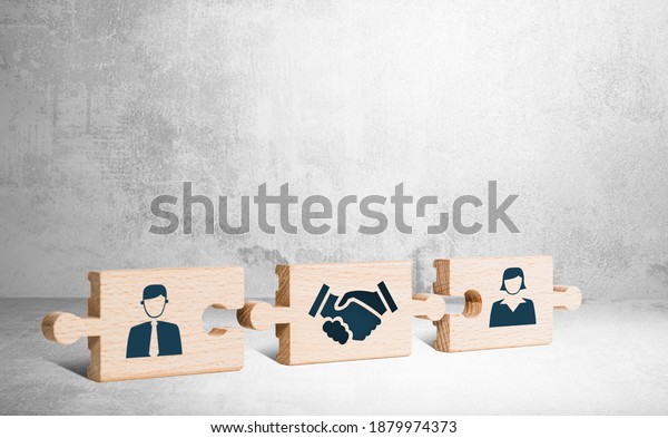 Wooden puzzle with icons of a man, mediator\
and woman. The concept of the role of a mediator in saving the\
family, mediation.