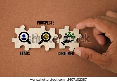 wooden puzzle with icons and the words Leads, Prospects, Customer.