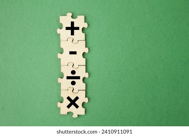 wooden puzzle with plus, minus, division and multiplication signs. mathematics learning concept