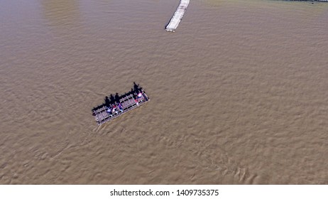 Wooden Raft As A Transportation To Cross People In The River View From Above With Aerial Drone