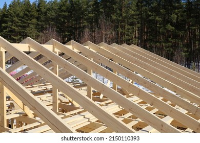 Wooden rafters of roofs, construction of frame house in rural areas, a texture repeating surface