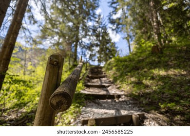 Wooden railing on a nice sunny hiking trail going uphill. - Powered by Shutterstock