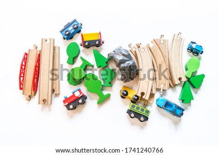 Wooden railway. A boy plays a toy train. Flat lay. Kindergarten and school