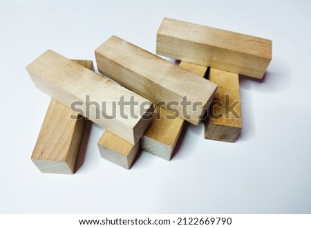 Wooden rectangular figures for playing django on a white background.

