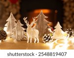 Wooden reindeer and pine trees with pinecones, glowing lights, and a cozy fireplace. Rustic decor with reindeer, trees, and pinecones for a warm holiday feel. Christmas ornaments and decoration.