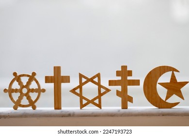 Wooden religious symbols :  Catholic, Islam, Judaism, Orthodox, Protestant, Buddhism and Hinduism. Interreligious, interfaith and spirituality concept. - Shutterstock ID 2247193723