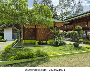 The wooden restaurant, nestled among lush greenery, exudes a warm and rustic charm, inviting diners to enjoy a cozy atmosphere while savoring delicious meals. - Powered by Shutterstock