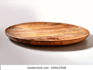 Wooden retro plate on a white background. Ready for the installation of food.