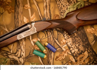 A wooden retro shotgun with shotgun shells