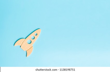 A wooden rocket on a blue background. retro style . The concept of space flights and achievements in high technologies. Business take off and grow. Space tourism. launching satellites. Minimalism - Powered by Shutterstock