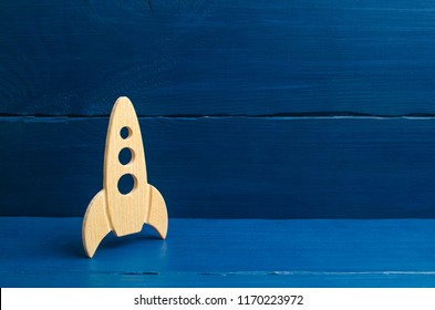 A wooden rocket on a blue background. The style is retro. The concept of space flights and achievements in high technologies. Business take off and grow. Space tourism. launching satellites - Powered by Shutterstock