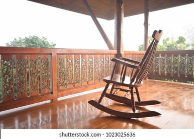 Wooden Rocking Chair On Front Porch.