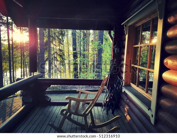 Wooden rocking chair on\
front porch 