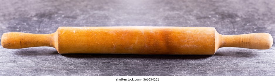 Wooden Rolling Pin On A Dark Table.