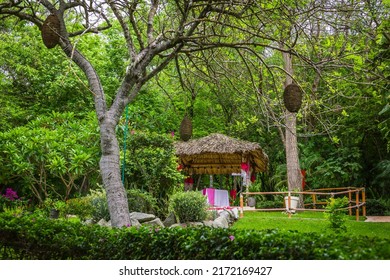 Wooden Romantic Tent With Love Motives In The Middle Of The Garden. Love Dinner Tent In The Garden. Romantic Dinner Setting In The Garden