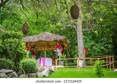 Wooden Romantic Tent With Love Motives In The Middle Of The Garden. Love Dinner Tent In The Garden. Romantic Dinner Setting In The Garden