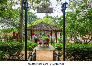 Wooden Romantic Tent With Love Motives In The Middle Of The Garden. Love Dinner Tent In The Garden. Romantic Dinner Setting In The Garden