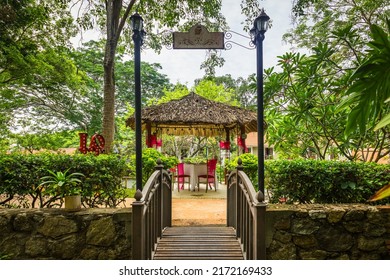 Wooden Romantic Tent With Love Motives In The Middle Of The Garden. Love Dinner Tent In The Garden. Romantic Dinner Setting In The Garden