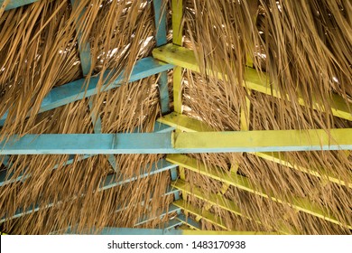 Wooden Roof Construction, Beach Hut Or Shack Interior, Covered With Dry Palm Leaves, Yellow And Turquoise Blue 