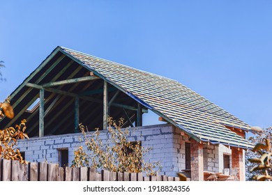 Wooden roof construction on a private house. Erection of a roof on a house from aerated concrete