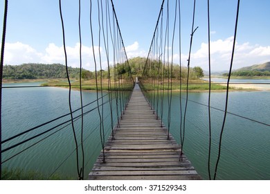 The wooden rope bridge across the lake at Kaeng Krachan National park Thailand 
