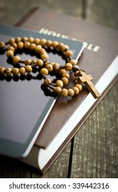 Wooden Rosary Beads With Computer Tablet On Old Wooden Table