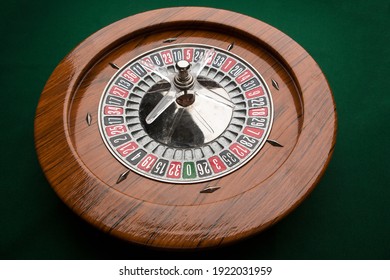 Wooden roulette isolated on green background