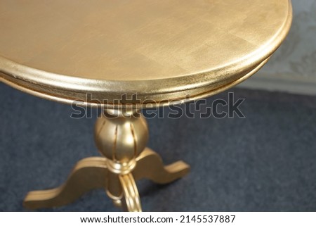 wooden round coffee table detail, wit gold glossy spray paint