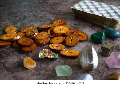 Wooden Runes And Tarot Cards On The Table