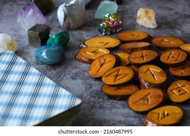 Wooden Runes And Tarot Cards On The Table