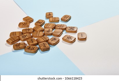 Wooden runes from the texture tree on a white-blue background - Shutterstock ID 1066118423