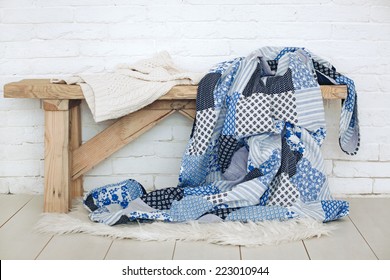 Wooden rustic bench with warm cozy bedding on it