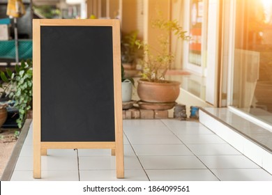 Wooden Rustic Blackboard In Front Of Restaurant Entrance. Mock Up Menu Blank Blackboard Sign Stand Shop Cafe Restaurant. Street Magnetic Sidewalk Chalkboard.