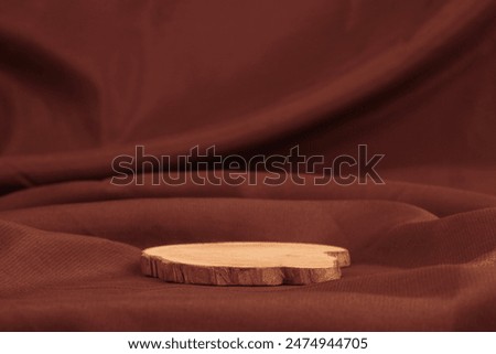 Wooden rustic pine tree platform podium on brown silk fabric background. Minimal empty display product presentation scene.