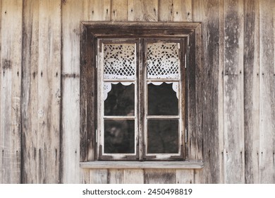 Wooden rustic window in cottage house. Lace curtains glass window home. Rusty architecture. Podlasie region in Poland vintage wall. Wood home wall facade. Village farm building. - Powered by Shutterstock