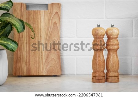 Wooden salt and pepper shakers on table, space for text