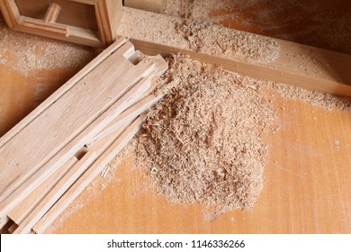 Wooden and Sawdust. Wood texture. Sawdust texture. Place for the text. In the workshop of the joiner. Shaving on the natural pine plank closeup.
