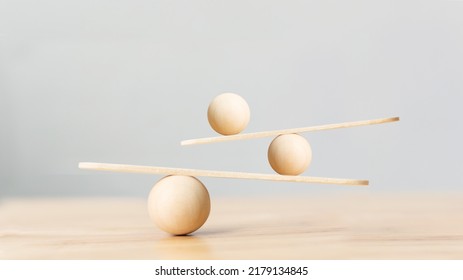 Wooden scale balancing on seesaw. Concept of harmony and balance in life and work - Shutterstock ID 2179134845