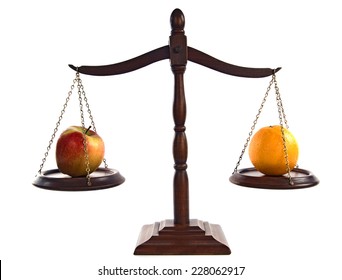 Wooden Scales Balancing An Apple And Orange On White/ Classic Scales Of Justice