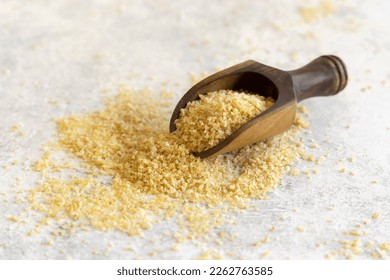 Wooden scoop of Dry uncooked bulgur wheat grain close up, copy space. Vegetarian and Vegan, Mediterranean and Middle Eastern cuisine. Healthy lifestyle - Powered by Shutterstock