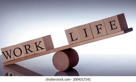 Wooden Seesaw Imbalance Between Life And Work On Black Background