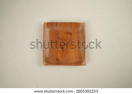 Wooden serving plates are dining and servingware crafted from natural materials such as teak, mahogany, or mango wood. Typically featuring a food-grade finish, these plates offer a warm, aesthetic appeal and are ideal for use as food photography props or serving vessels.