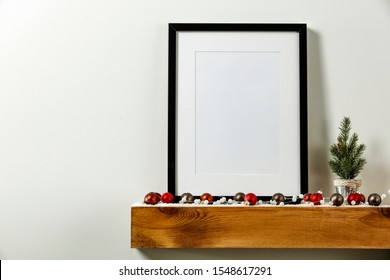 Wooden Shelf Of Free Space For Your Decoration. White Background Of Wall. Christmas Composition With Frame And Empty Space For Your Photo. Winter Time. Copy Space. 