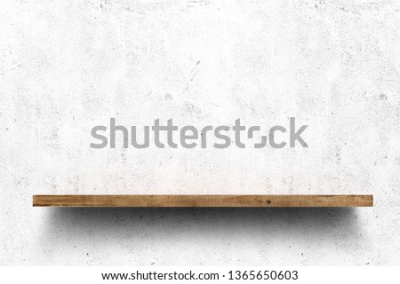 Wooden shelf over white concrete wall background