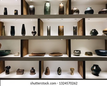 A Wooden Shelves Full With Antique Pots, Pottery, Jars And Vases.A Display Shelf Of Old Ceramic Vase And Bowls.