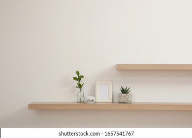 Wooden shelves with plants and photo frame on light wall - Shutterstock ID 1657541767