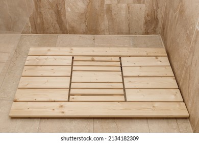 Wooden Shower Mat On Tile Floor In Cabin In Bathroom