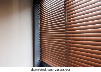 Wooden shutters blinds or windows blinds decorate in liveing room.