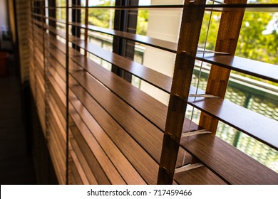 Wooden shutters blinds (Windows blinds) with the light sunshine - Shutterstock ID 717459466